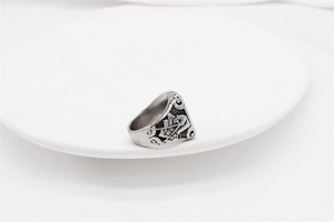 Close-up of vintage reaper relief on silver titanium steel ring with gothic scrollwork