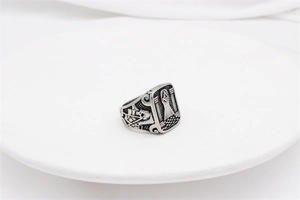Macro view of Freemason symbol and skull carvings on retro stainless steel men's ring