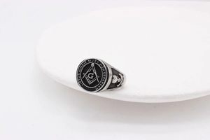 Macro detail of Freemasonry ring with Latin inscription and skull design on stainless steel