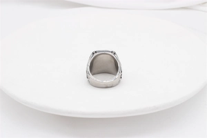 Detailed view of vintage silver steel ring with side engravings on white tray