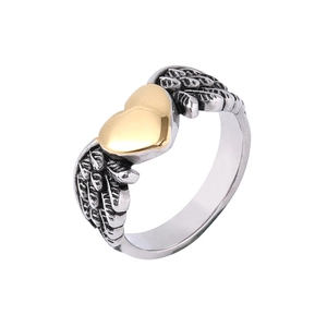 Detail of two-tone stainless steel ring showing golden heart and silver angel wings