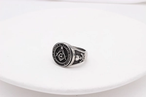 Close-up of vintage Freemason signet ring with skull relief and Latin engraving