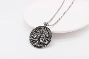 Detail of vintage round coin pendant with Egyptian relief and Liberty 1913 engraving