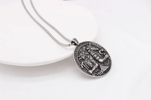 Close-up of vintage Anubis coin pendant featuring Liberty 1913 engraving in aged steel