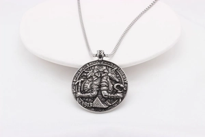 Macro view of vintage Egyptian Anubis coin pendant with Liberty 1913 relief engraving