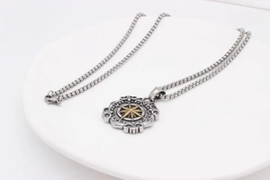 Detailed close-up of retro stainless steel compass pendant with embossed gold star