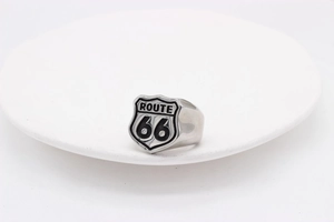 Macro shot of vintage Route 66 shield sign on silver stainless steel biker ring