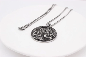 Macro shot of silver Anubis pendant showing Liberty 1913 engraving and bead chain