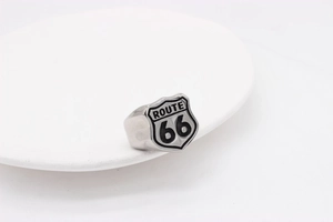 Close-up of vintage Route 66 shield ring in silver stainless steel on white plate