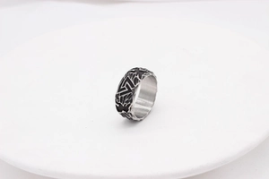 Detailed view of vintage Viking Valknut symbol engraved on black steel ring band