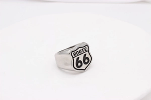 Macro detail of vintage Route 66 shield logo on silver stainless steel biker ring