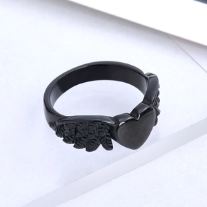 Minimalist black stainless steel heart ring with detailed angel wings in matte finish
