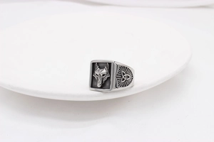 Detailed view of Nordic Viking wolf head relief and Celtic knot patterns on steel ring
