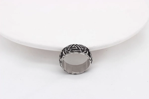 Macro detail of vintage Viking Valknut symbol on men's oxidized titanium steel ring