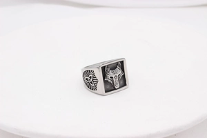 Detailed close-up of a stainless steel signet ring featuring a wolf head and Celtic knot