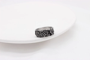 Macro detail of vintage Valknut symbol engraving on men's stainless steel Viking ring