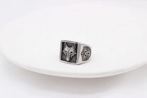 Detail of Viking wolf head relief and Celtic knots on vintage stainless steel ring