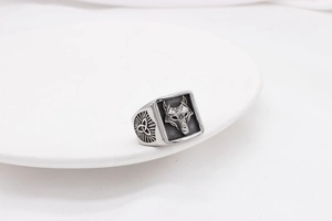 Detailed close-up of a vintage steel ring featuring a wolf head emboss and Celtic knots