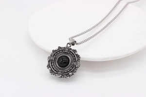 Macro shot of Gothic pendant featuring a black gemstone with intricate Baroque carvings