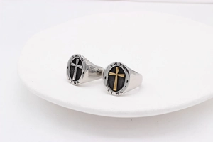 Detailed macro view of vintage cross rings with engraved Swim and Sink lettering