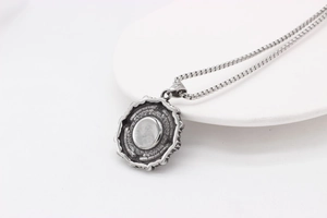 Macro detail of retro gothic stainless steel pendant with black gemstone and square chain