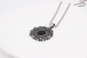 Detailed macro view of vintage gothic pendant with black gemstone and ornate metalwork