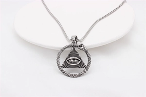 Macro detail of Egyptian Pharaoh Eye of Providence pendant with Ouroboros on snake chain