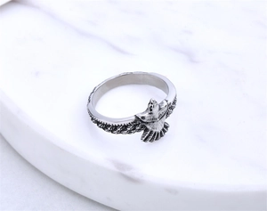 Detailed close-up of eagle wings on vintage silver steel ring with oxidized finish