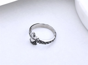 Detailed view of vintage eagle ring with antique silver finish and feather carvings
