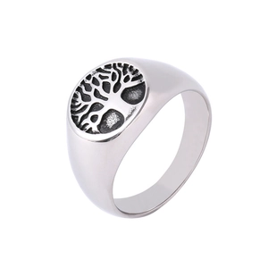Macro view of vintage silver signet ring featuring detailed Tree of Life engraving