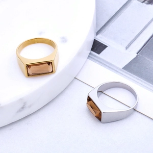 Retro titanium steel rings with rectangular champagne stones on marble tray