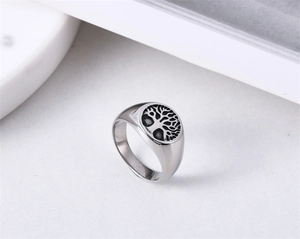 Detailed close-up of a silver Tree of Life signet ring with vintage black engraving