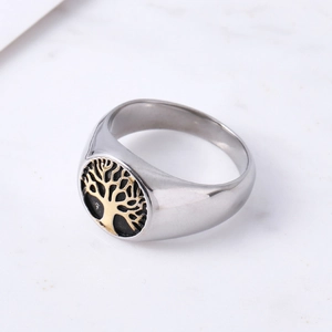 Minimalist silver stainless steel ring with a golden tree of life emblem on black
