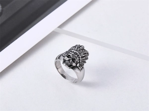 Close-up of retro punk style silver skull ring with detailed Indian feather headdress