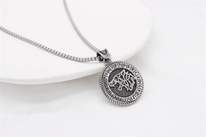 Detail of Nordic Viking Wolf pendant with intricate Fenrir totem and Rune embossed edge