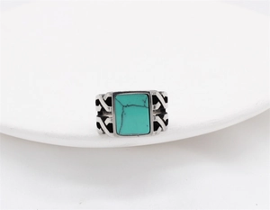 Macro view of vintage stainless steel ring with rectangular turquoise stone and weave details
