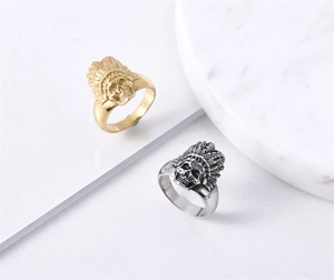 Detailed close-up of retro Indian skull rings with feather headdress in gold and silver
