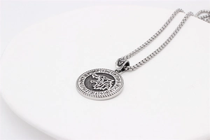 Close-up of vintage Viking wolf head pendant with Nordic runes in antique silver finish