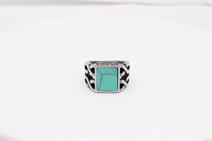 Detailed close-up of retro silver steel ring with square turquoise and hollowed weaving