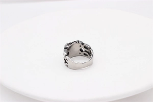 Detail of silver titanium ring featuring Greek Key patterns and geometric hollow carvings