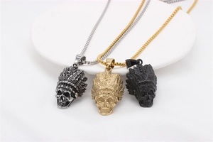Detailed view of Native American chief skull pendants in silver, gold, and matte black steel