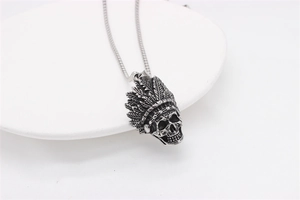 Macro shot of retro silver Indian chief skull pendant showing detailed feather textures