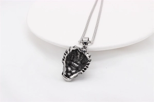 Detailed view of hollowed-out wolf head metal pendant in vintage silver steel finish