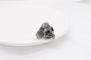 Macro detail of skull ring with mandala floral engraving and vintage steel finish