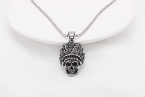 Close-up of vintage steel Indian chief skull pendant with detailed feather texture