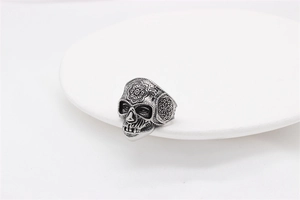 Macro shot of retro stainless steel skull ring with vintage mandala floral engravings
