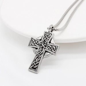 Vintage Viking Celtic cross pendant necklace in silver stainless steel on white plate