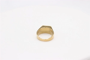 Macro view of gold-plated signet ring showing thick band and smooth polished back side