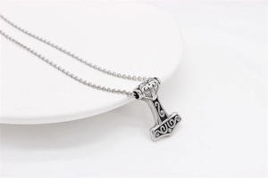 Macro shot of Viking Mjölnir pendant with vintage silver finish and intricate swirl patterns