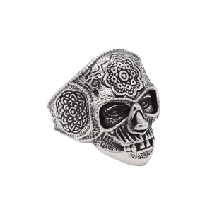 Vintage stainless steel skull ring with intricate floral engraving from a 45-degree angle